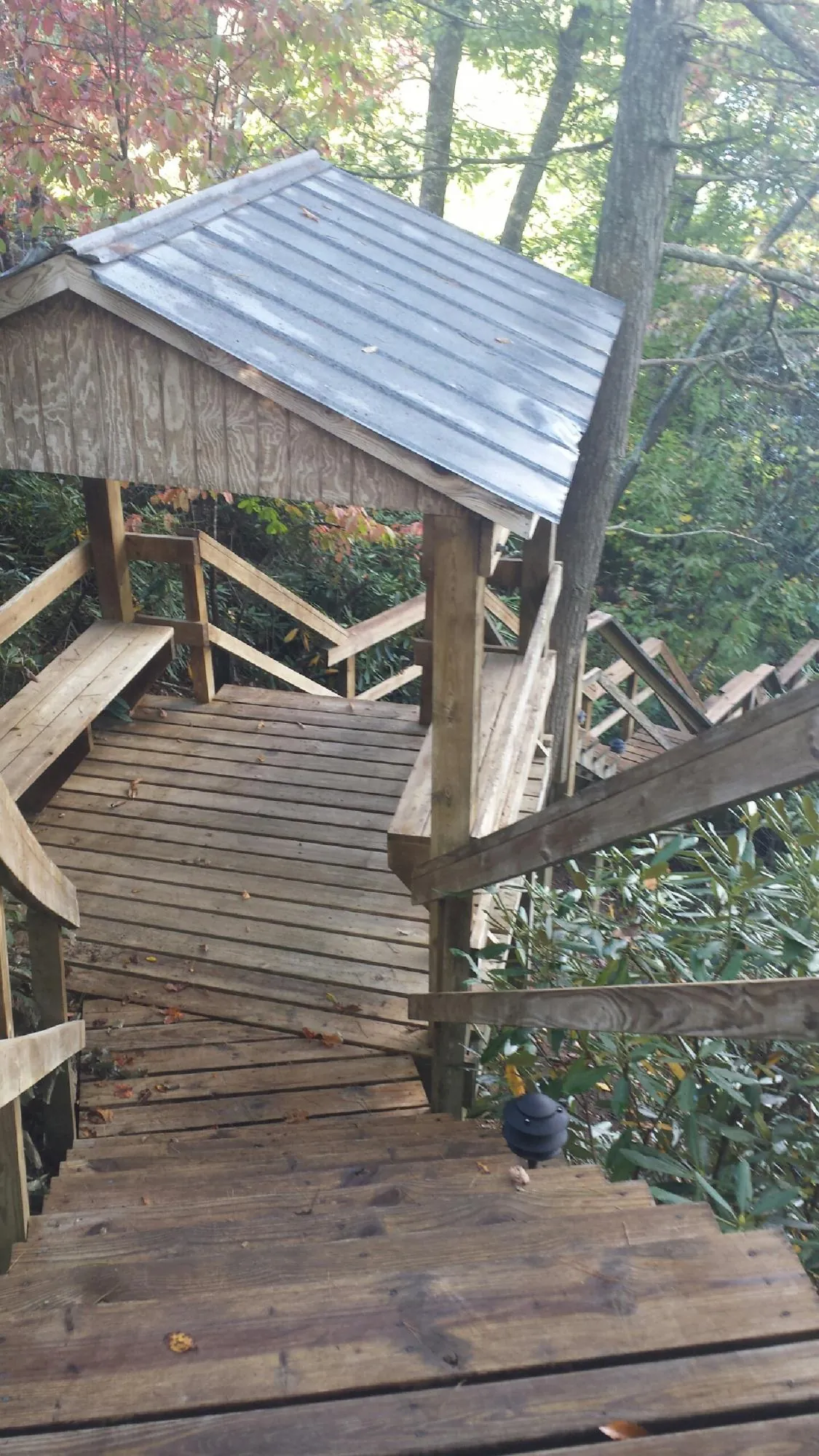 Metal roofed shelter over wooden steps on a wooded walkway — Skylight Repair & Installation work by our crew in South Glastonbury