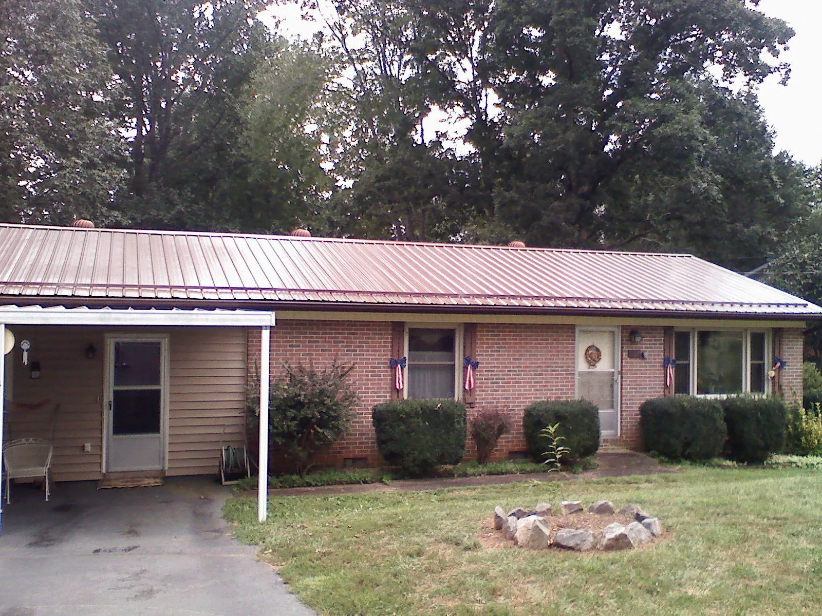 Bronze metal roof and carport on a brick ranch home — Roof Repair work by our crew in South Glastonbury